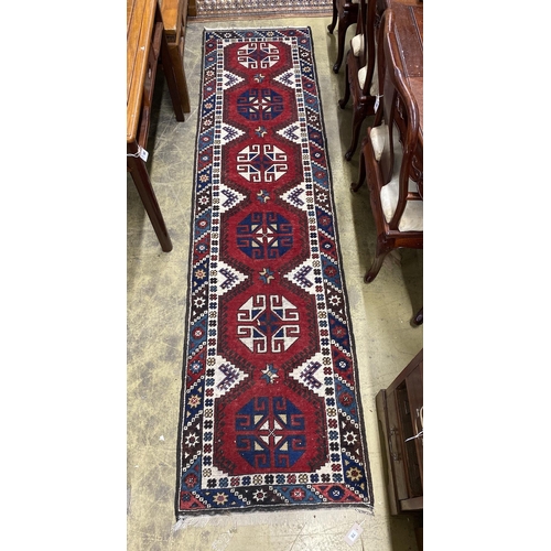 70 - A Caucasian style red ground runner, 274 x 72cm