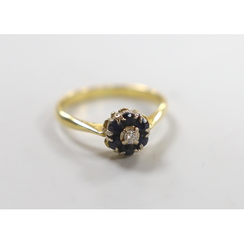 981 - A modern yellow metal, sapphire and diamond cluster set ring, size M, gross weight 2.8 grams.