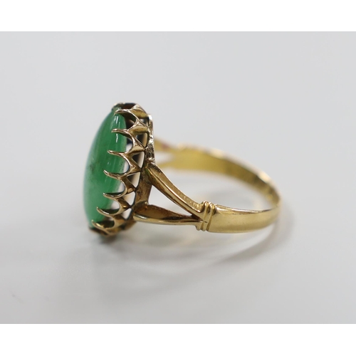 983 - A Chinese yellow metal and cabochon jade set oval ring, size Q/R, gross weight 5 grams.