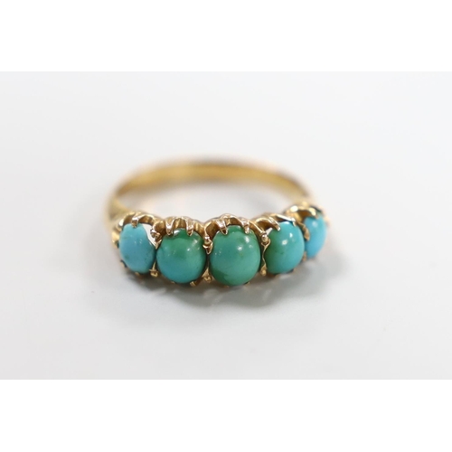 987 - A yellow metal and graduated five stone cabochon turquoise set half hoop ring, size G/H, gross weigh... 