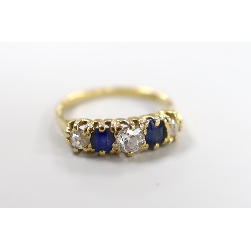 997 - An 18ct, three stone diamond and two stone sapphire set half hoop ring, size M, gross weight 3.3 gra... 