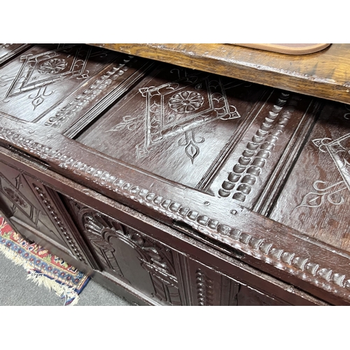 1237 - A 17th century later carved oak coffer, width 132cm