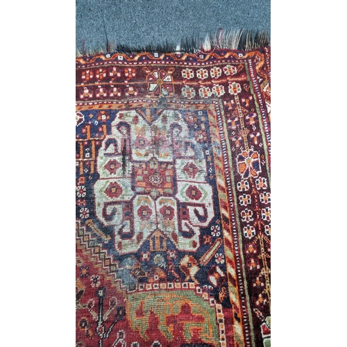 1246 - A Caucasian red ground carpet 260cm x 160cm.
