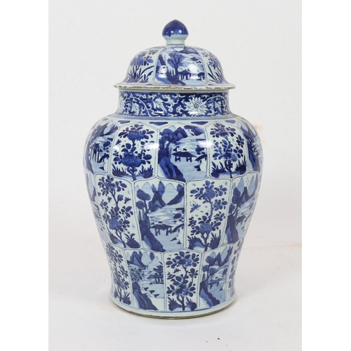 106 - A massive Chinese blue and white jar and cover, Kangxi period, painted with alternating landscape an... 