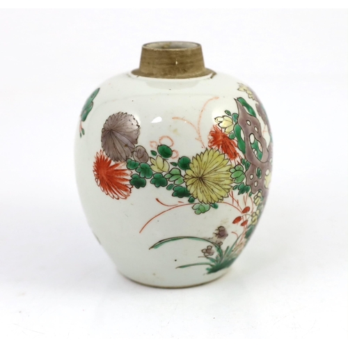 107 - A Chinese famille verte small ovoid jar, Kangxi period, painted with rocks, flowers, foliage and two... 