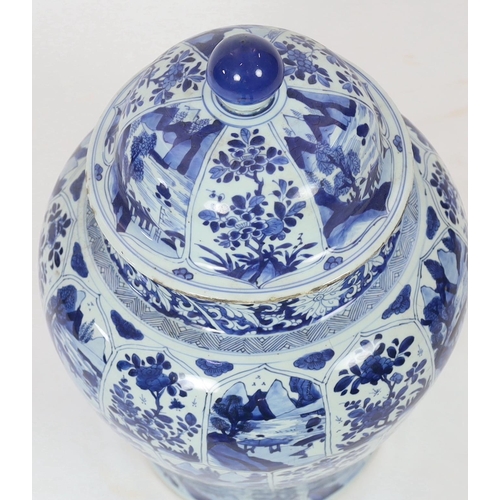 106 - A massive Chinese blue and white jar and cover, Kangxi period, painted with alternating landscape an... 