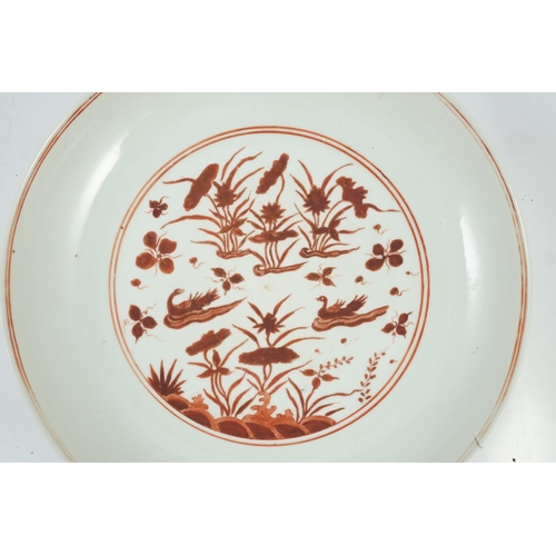 113 - A large Chinese iron red enamelled lotus pond dish, Wanli mark and possibly of the period, the cen... 