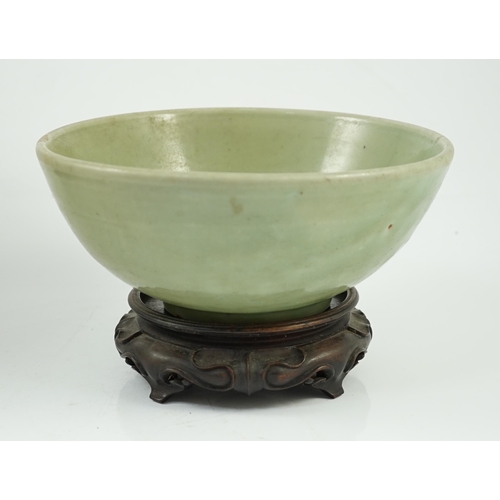 143 - A Chinese Ming Longquan celadon bowl, 15th century, the interior moulded to the centre with a flower... 