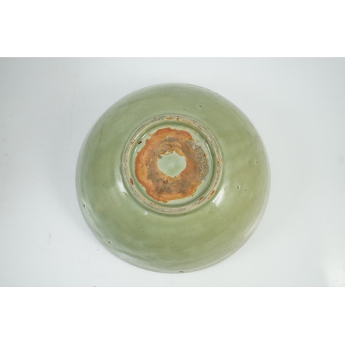 143 - A Chinese Ming Longquan celadon bowl, 15th century, the interior moulded to the centre with a flower... 