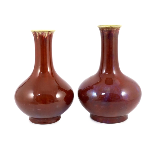 146 - Two large Chinese flambé glazed bottle vases, 18th century, each covered in a purple streaked crimso... 