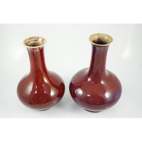 146 - Two large Chinese flambé glazed bottle vases, 18th century, each covered in a purple streaked crimso... 