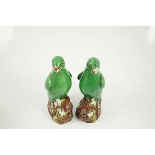 155 - A pair of Chinese green glazed models of parrots, Kangxi period, each perched on a tree bough with p... 