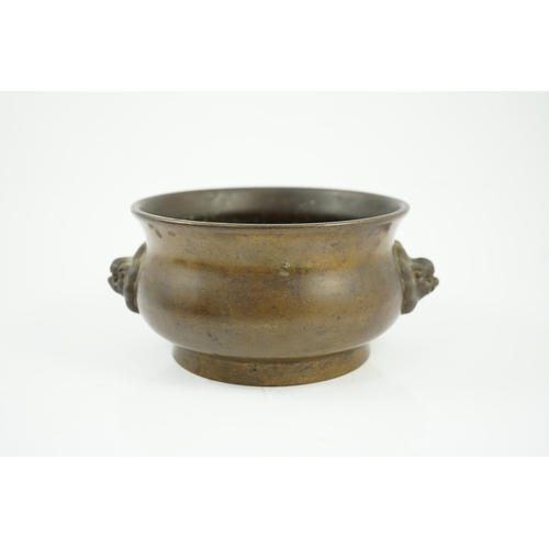 159 - A Chinese bronze censer, gui, 18th century, with olive-brown patina, cast with a pair of lion-mask h... 