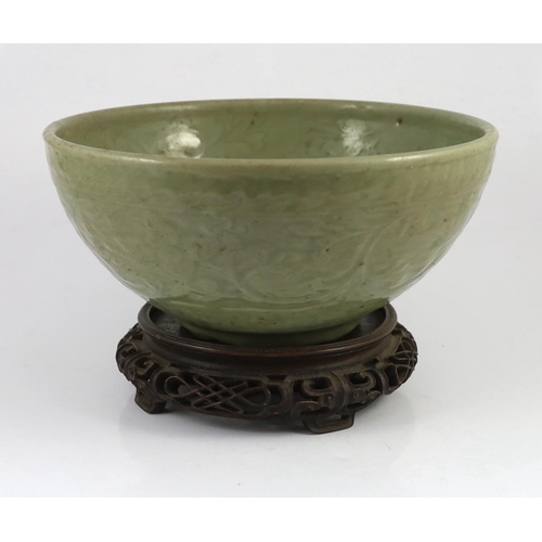 163 - A large Chinese Ming carved Longquan celadon deep bowl, first half 15th century, heavily potted, the... 