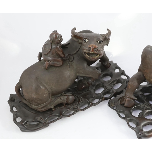 171 - A pair of large Chinese carved hardwood buffalo groups, early 20th century, each well carved with th... 