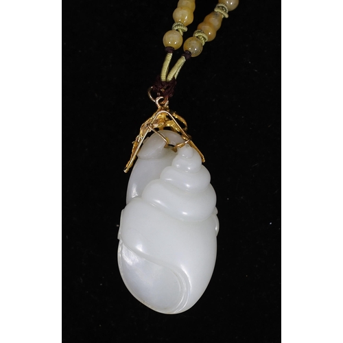 179 - A Chinese white jade conch shell yellow metal mounted pendant, the pendant carved with a large con... 