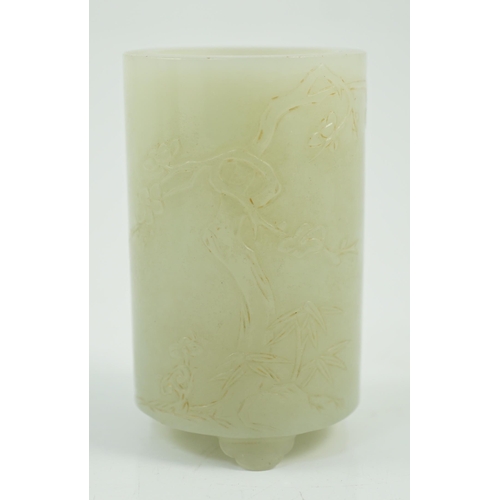 186 - A small Chinese pale celadon jade brushpot, 19th century, carved in relief with a blossoming plum tr... 