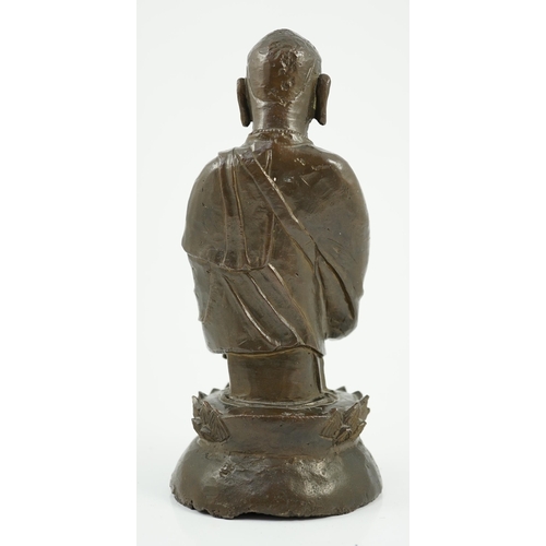 190 - A Chinese bronze figure of a standing luohan, late Ming dynasty, depicted wearing long flowing robes... 