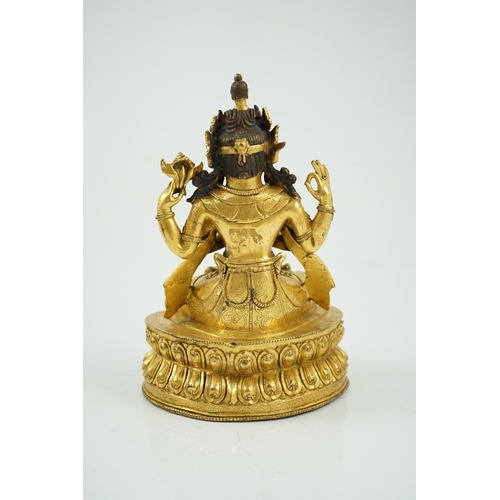 194 - A Sino-Tibetan gilt bronze figure of Shadakshari Lokeshvara, possibly 18th century, seated in vajrap... 