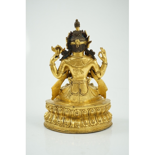 194 - A Sino-Tibetan gilt bronze figure of Shadakshari Lokeshvara, possibly 18th century, seated in vajrap... 