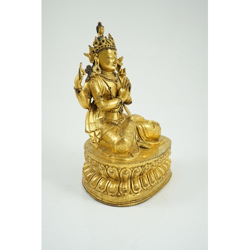 194 - A Sino-Tibetan gilt bronze figure of Shadakshari Lokeshvara, possibly 18th century, seated in vajrap... 