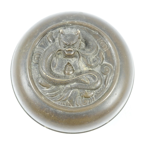 196 - A Chinese bronze 'dragon' circular incense box and cover, Xuande seal mark, 18th/19th century, the c... 