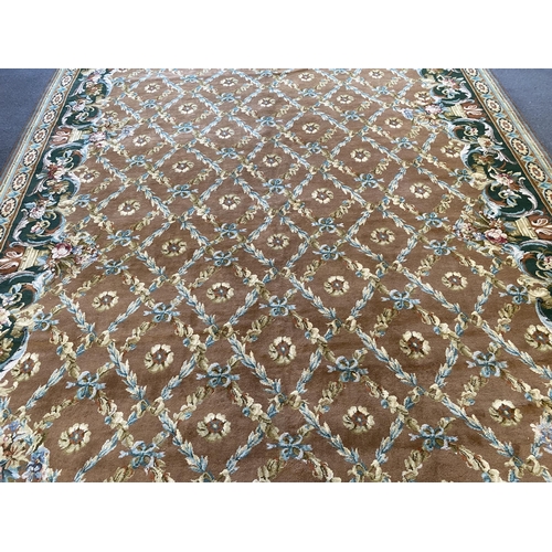 227 - A large Indian carpet, with foliate trellis ribbon and paterae motifs across a pale brown ground, wi... 