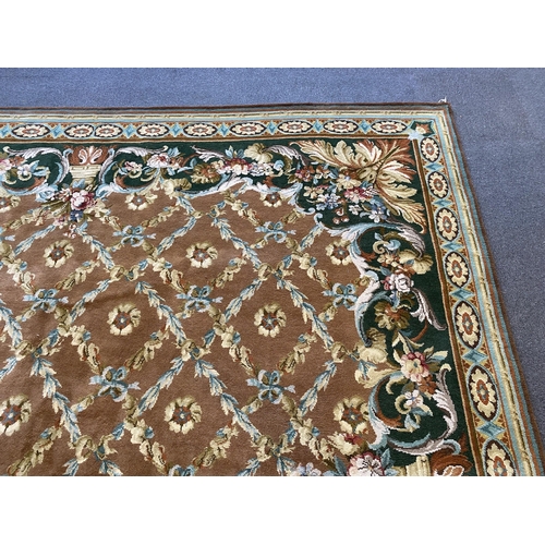 227 - A large Indian carpet, with foliate trellis ribbon and paterae motifs across a pale brown ground, wi... 