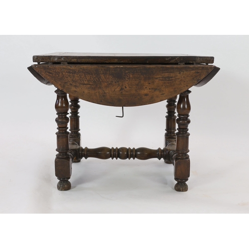 229 - A late 17th century Spanish walnut dining table, the rectangular top with four demi-lune flaps on tu... 