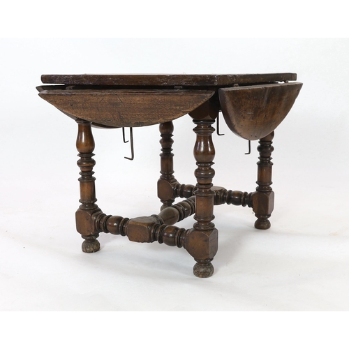 229 - A late 17th century Spanish walnut dining table, the rectangular top with four demi-lune flaps on tu... 