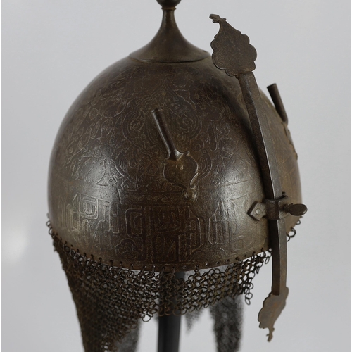 23 - A 19th century Persian Kulah Khud, with spike finial and silvered decoration including an inscriptio... 