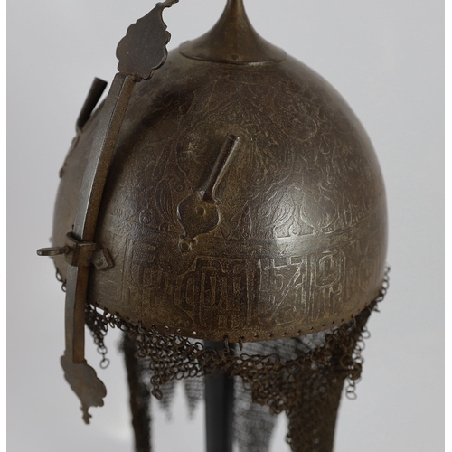 23 - A 19th century Persian Kulah Khud, with spike finial and silvered decoration including an inscriptio... 