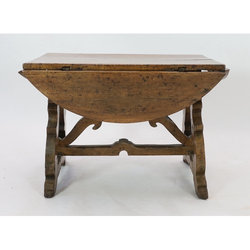 230 - A mid 17th century Spanish walnut dining table, with four demi-lune flaps on scrolled trestle suppor... 