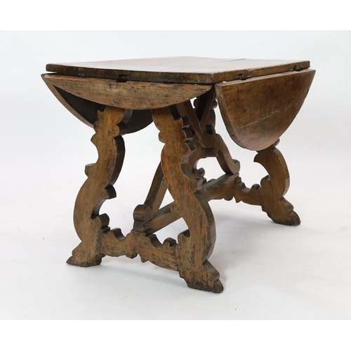 230 - A mid 17th century Spanish walnut dining table, with four demi-lune flaps on scrolled trestle suppor... 