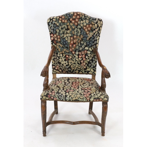 235 - A Louis XIV walnut armchair, with arched needlework covered upholstered back and seat, scroll arms, ... 