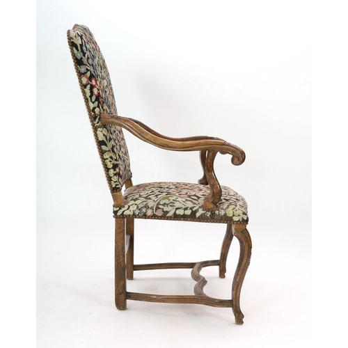 235 - A Louis XIV walnut armchair, with arched needlework covered upholstered back and seat, scroll arms, ... 