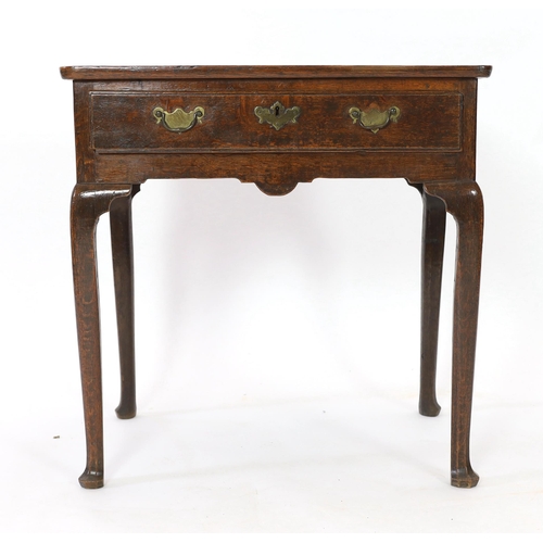 239 - A George II oak side table, c.1750, the rectangular moulded top above a drawer and shaped apron, on ... 