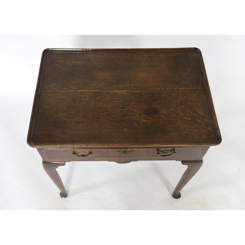 239 - A George II oak side table, c.1750, the rectangular moulded top above a drawer and shaped apron, on ... 