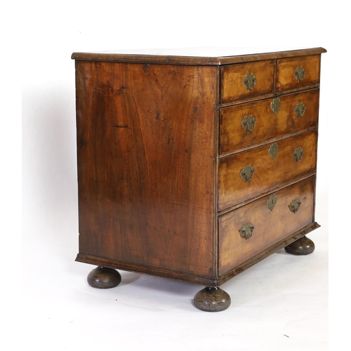 241 - A William and Mary walnut chest of drawers, c.1690, inlaid with feather banding, the segmented quart... 