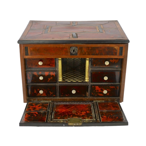 242 - An early 18th century Indo Portuguese ebony, satinwood and red tortoiseshell travelling case, the hi... 