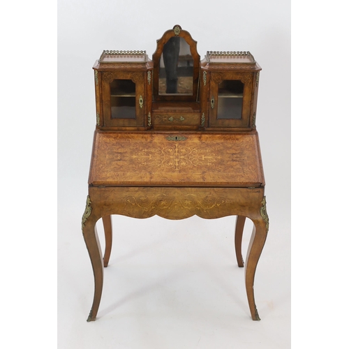 246 - A Victorian marquetry inlaid walnut bonheur du jour, the raised mirrored back with single drawer and... 