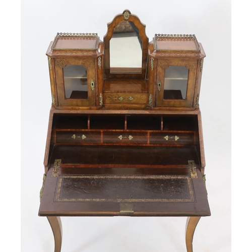 246 - A Victorian marquetry inlaid walnut bonheur du jour, the raised mirrored back with single drawer and... 