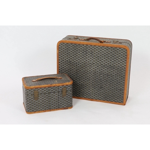 25 - A 1940's Goyard vanity case with matching suitcase, each with tan leather mounts, the vanity case wi... 