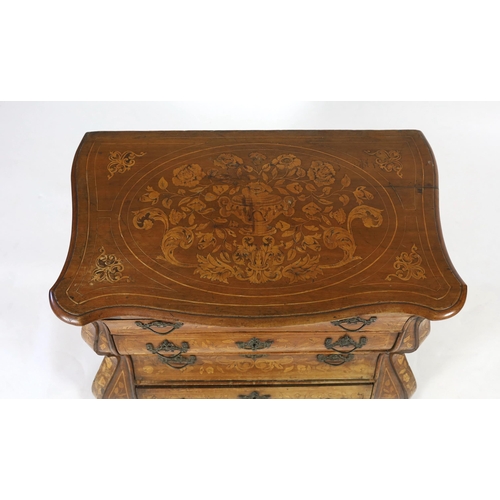 253 - An early 19th century Dutch walnut and marquetry bombé front commode, with serpentine top and four l... 