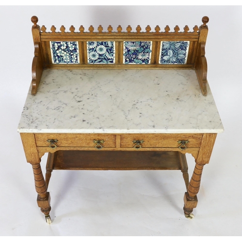 255 - Lewis Foreman Day (1845-1910). A Victorian Aesthetic movement golden oak and marble washstand, inset... 