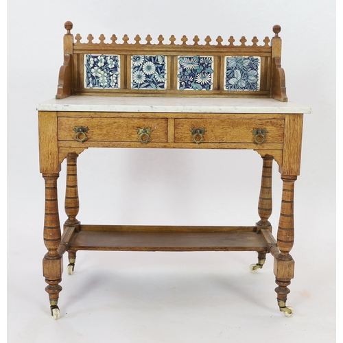 255 - Lewis Foreman Day (1845-1910). A Victorian Aesthetic movement golden oak and marble washstand, inset... 