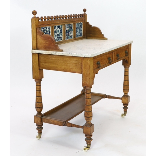 255 - Lewis Foreman Day (1845-1910). A Victorian Aesthetic movement golden oak and marble washstand, inset... 