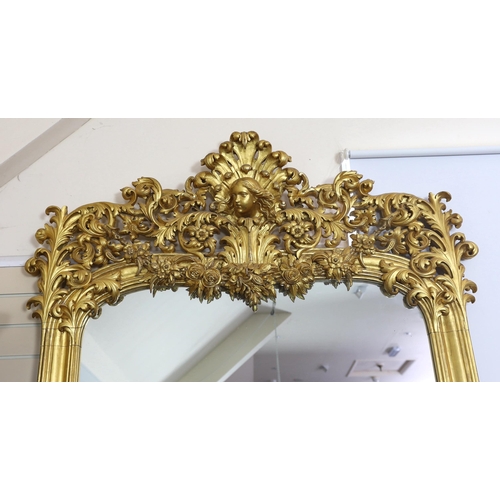 259 - An ornate early 20th century carved giltwood wall mirror, with elaborate foliate scroll work top inc... 