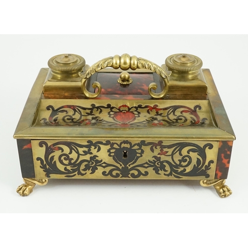 34 - A 19th century Louis XIV style red boulle inkstand, with loop handle, two brass wells and base drawe... 