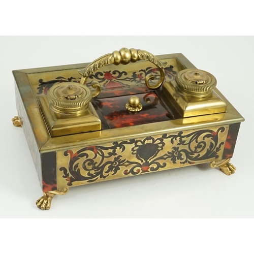 34 - A 19th century Louis XIV style red boulle inkstand, with loop handle, two brass wells and base drawe... 